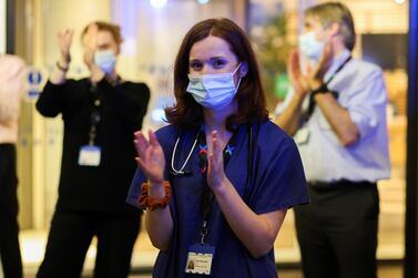 NHS staff participate in a national clap for late Captain Sir Tom Moore and all NHS workers, amidst the coronavirus disease outbreak, at Chelsea and Westminster Hospital in London, Britain February 3, 2021. REUTERS