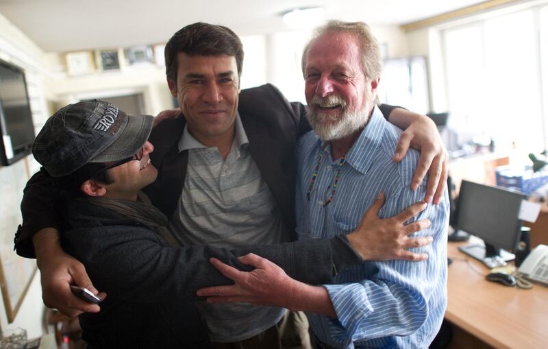 In this file photo, taken in 2012, AFP photographer Shah Marai, centre, embraces colleagues Massoud Hossaini and Lawrence Bartlett after Hossaini had won the Pulitzer Prize, at the AFP office in Kabul. AFP's chief photographer in Kabul, Shah Marai, was killed in a secondary explosion targeting a group of journalists who had rushed to the scene of a suicide blast in the Afghan capital. Here is a collection of his work. Johannes Eisele / AFP