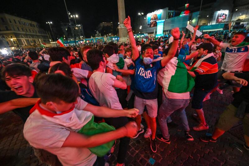 Fans of Italy react after Italy scored their third goal. AFP