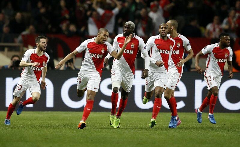 Kylian Mbappe, second left, scored the opening goal for Monaco on their way to a 3-1 second leg victory which ensured their place in the Uefa Champions League quarter-finals. Guillaume Horcaiuelo / EPA 