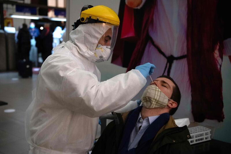 A health worker collects a nasal swab sample from a passenger to be tested for COVID-19 before he is allowed to board a ferry to Buenos Aires, at Argentinian ferry service company Buquebus' terminal in the port of Montevideo, on July 10, 2020. Technicians of the Technological Laboratory of Uruguay (LATU) set up a floating laboratory on a ferryboat of Buquebus -the only liner linking the capitals- after the polemic entry to Uruguay of two Argentinian citizens infected with COVID-19 in June. The Uruguayan government of President Luis Lacalle Pou requires since Monday that travellers from abroad have a negative test for the new coronavirus done within 72 hours before the trip and another one seven days after, since flights from Europe were resumed. / AFP / Pablo PORCIUNCULA
