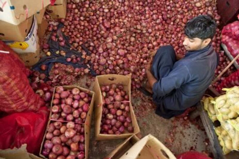 July 07.  Onions are sorted to be re-sold at the Dubai Fruit and Vegetable market. July 07, Dubai. United Arab Emirates (Photo: Antonie Robertson/The National)