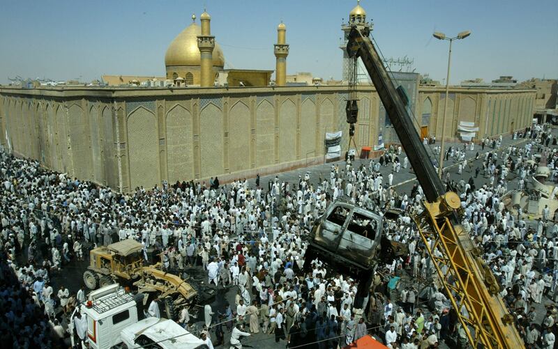 August 30, 2003: A burnt-out car is removed from outside Najaf’s Imam Ali Mosque, the holiest Shiite shrine in Iraq, a day after 87 people were killed in a car bomb attack. The attack raises sectarian tension as thousands of Iraqi Shiites, some of them backed by Iran, demand the right to form militias. Reuters