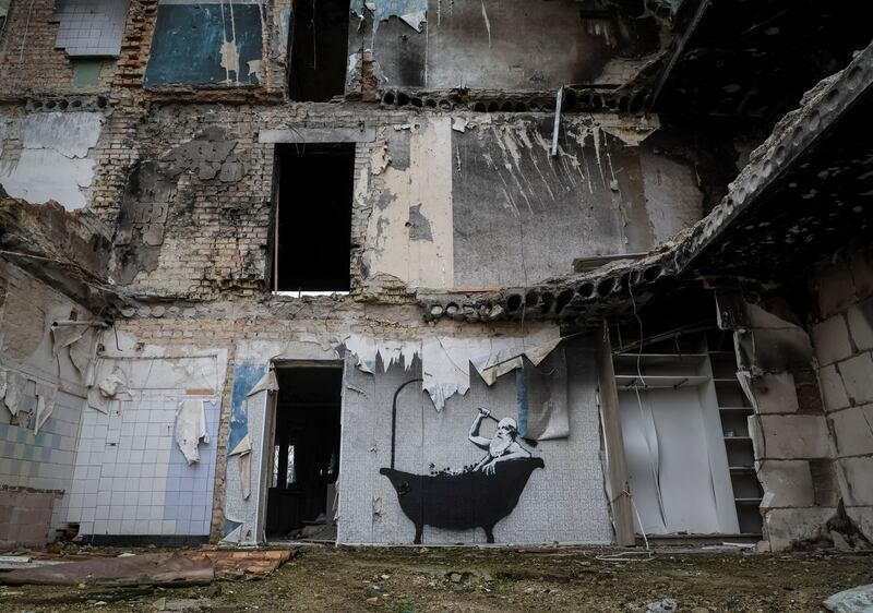 A spray-painted image of someone taking a bath inside a gutted building in the Ukrainian village of Horenka, near Kyiv. Reuters