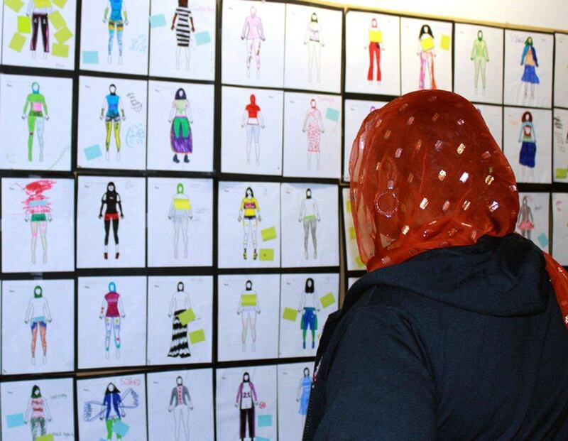 A woman looks at the design prototype drawings for Muslim girls' sportswear in Minneapolis, Minnesota, US. Jeff Baenen / AP
