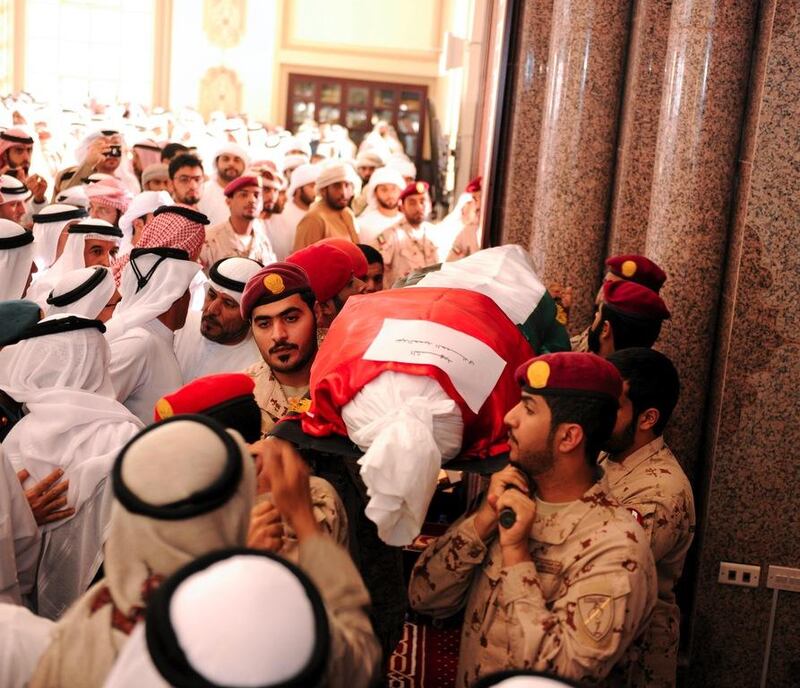 Ahmed Juma Al Zaabi, Deputy Minister of Presidential Affairs, helps carry the body of Abdulhamid Al Hammadi at the funeral prayers for Al Hammadi and Mohammed Al Bastaki in Abu Dhabi. Wam