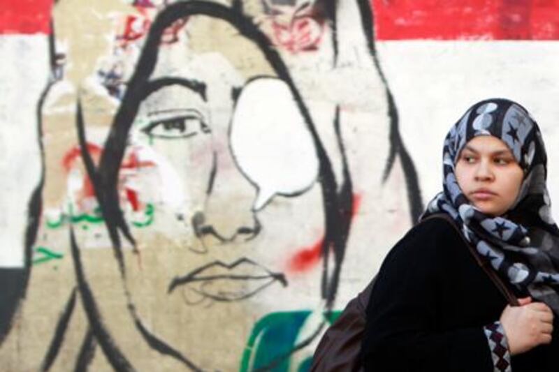 A woman walks past a mural in Cairo. Reuters