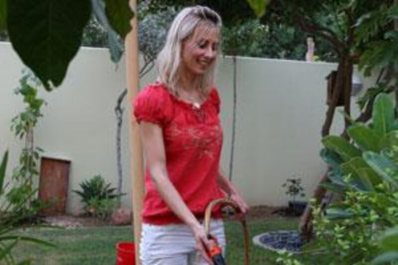 Adele Nigrini maintains her garden with waste water cleaned by her own recycling system, below.