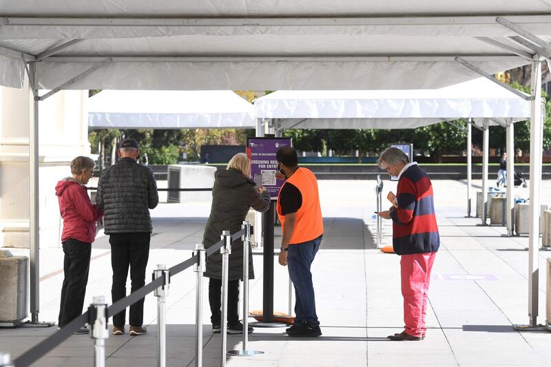 People wait outside a Covid-19 vaccination centre to receive the shot in Melbourne, Australia, on April 21, 2021. AFP