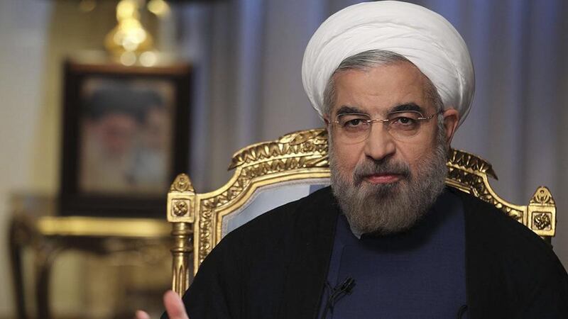 Hassan Rouhani said Iran will stay committed to the nuclear deal as long as it serves his country's interests. Rouzbeh Jadidoleslam / AP Photo