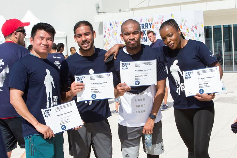 ABU DHABI, UNITED ARAB EMIRATES - Participants getting their certificates after running  at the Terry Fox Run, Corniche Beach.  Leslie Pableo for The National