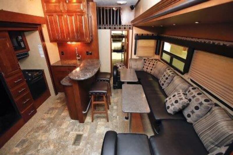 Interior photograph of the kitchen and living room in the XLR Thunderbolt RV by Forest River on sale at Gulf Coast RVs in Dubai