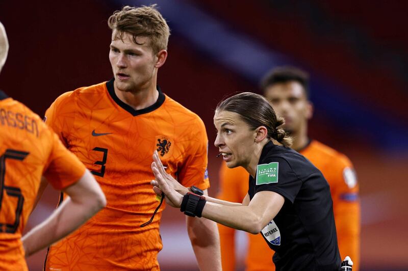 epa09101752 Dutch player Matthijs de Ligt listens to French referee Stephanie Frappart. EPA