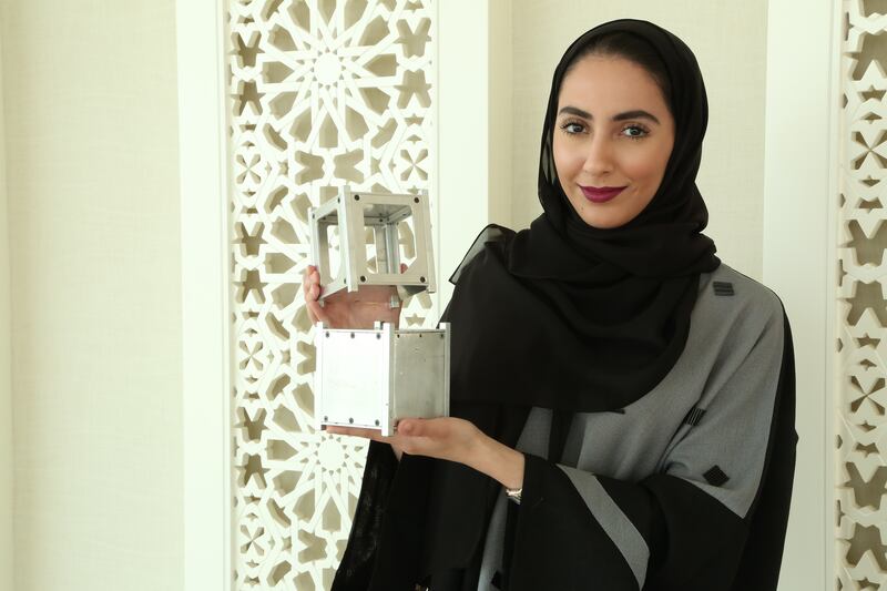 Fatma Loota, Deputy project manager of Nayif-1 at the MBRSC who is holding a model of the nanosatellite Nayif-1.(Photo-Courtesy-MBRSC) *** Local Caption ***  2015-09-14 14.20.29-2.jpg