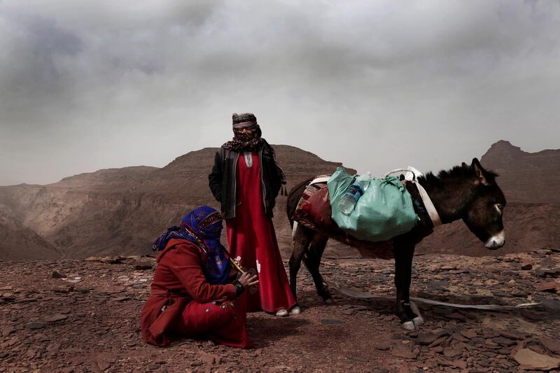 Umm Yasser, the first Bedouin female guide from the Hamada tribe, looks at Umm Soliman as she plays the flute, near Wadi Sahw, Abu Zenima, in South Sinai, Egypt. AP Photo