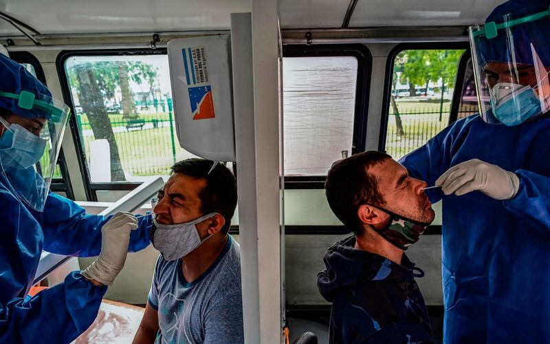 Argentinian dentists, who graduated from the University of Buenos Aires, work as volunteers collecting samples for Covid-19 tests in La Boca neighbourhood of Buenos Aires. AFP