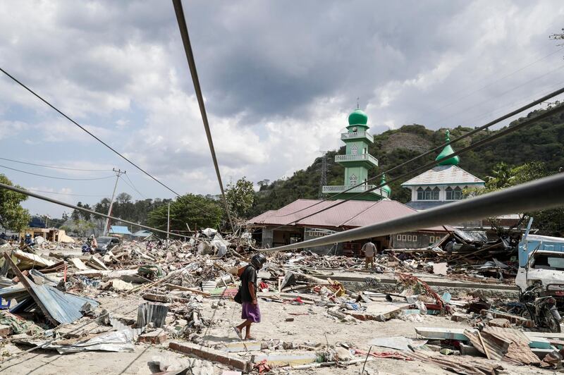 A man walks on the rubble in Donggala. EPA