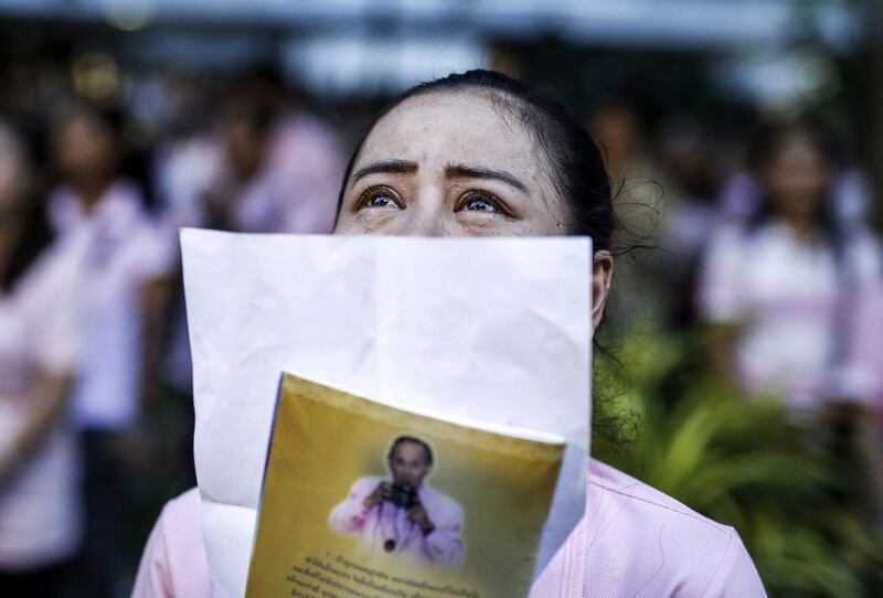 A Thai well-wisher weeps while praying for Thai King Bhumibol Adulyadej who died on October 13, 2016. Rungroj Yongrit/EPA
