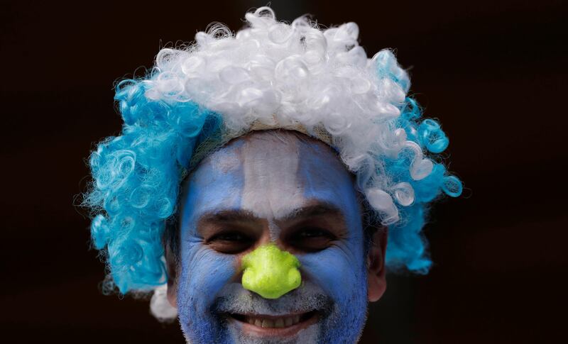 
                  An Argentina soccer fan decked out in his team's colors smiles prior a World Cup qualifying soccer match against Peru at la Bombonera stadium in Buenos Aires, Argentina, Thursday, Oct. 5, 2017. (AP Photo/Natacha Pisarenko)
               
