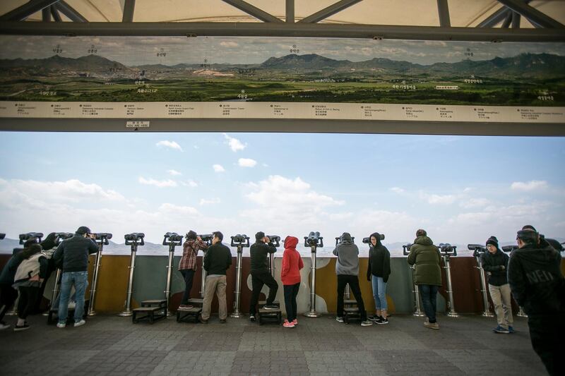 PAJU, SOUTH KOREA - APRIL 07:  Tourists look towards the Kaesong Industrial Complex in North Korea as they visit Dora Observatory inside the fortified Demilitarised Zone (DMZ) on April 7, 2018 in Paju, South Korea. The Kaesong Industrial Complex has been closed by the South Korean government since February 2016 following the North's missile launches. On April 27, 2018, South Korean President Moon Jae-in and North Korean leader Kim Jong-un will hold their first meeting in the joint security area (JSA) inside the DMZ amid international attention and before the summit between Kim and the U.S. president Donald Trump.  (Photo by Jean Chung/Getty Images)