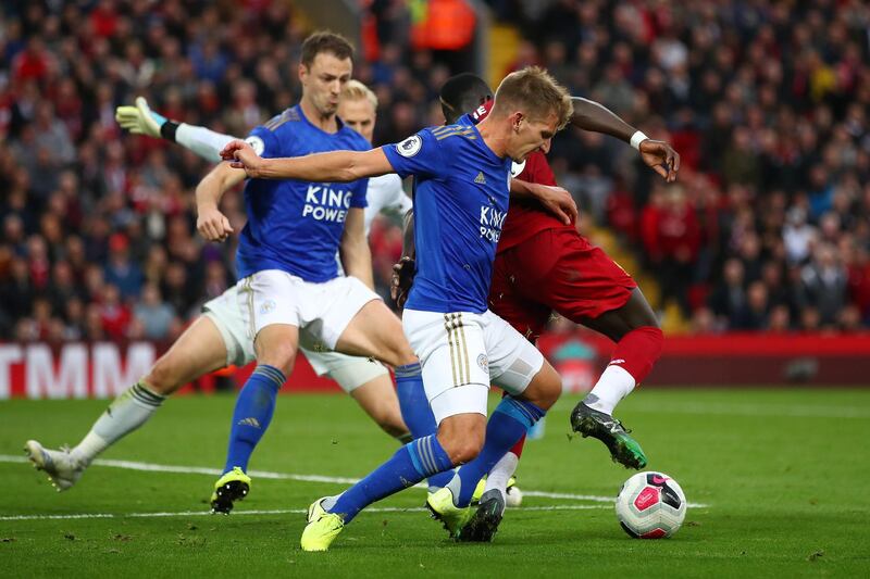 Mane is fouled by Marc Albrighton of Leicester City. A penalty was later awarded. Getty