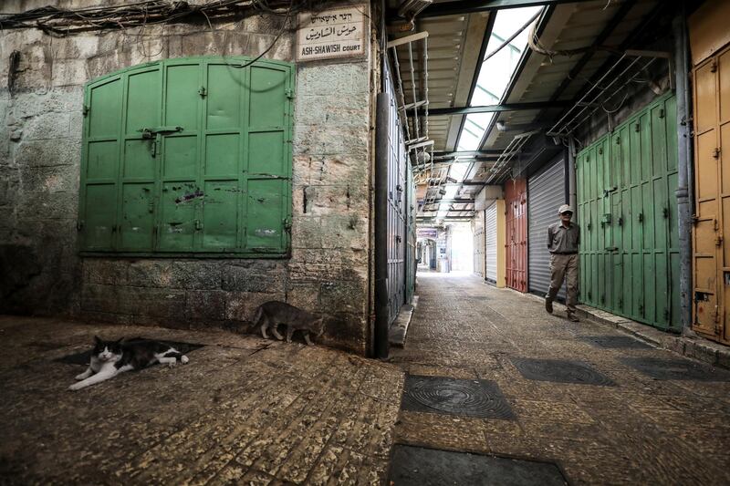 A man walks past closed shops during a general strike at a market in Jerusalem's Old City. Reuters