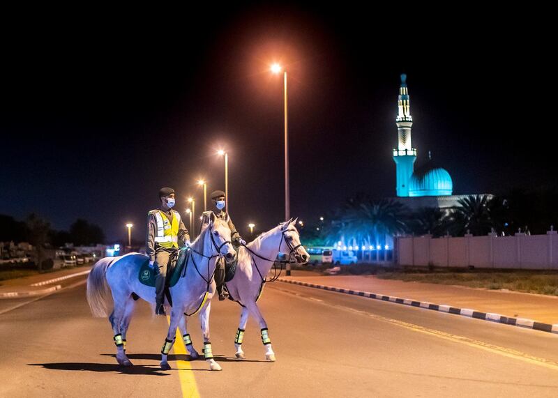 DUBAI, UNITED ARAB EMIRATES. 16 APRIL 2020. 
Dubai Mounted Police officers, in Al Aweer, patrol residential and commercial areas to insure residents are staying safe indoors during COVID-19 lockdown. They patrol the streets from 6PM to 6AM.

The officers of the Dubai Mounted Police unit have been playing a multifaceted role in the emirate for over four decades. 

The department was established in 1976 with seven horses, five riders and four horse groomers. Today it has more than 130 Arabian and Anglo-Arabian horses, 75 riders and 45 groomers.

All of the horses are former racehorses who went through a rigorous three-month-training programme before joining the police force. Currently, the department has two stables – one in Al Aweer, that houses at least 100 horses, and the other in Al Qusais, that houses 30 horses.

(Photo: Reem Mohammed/The National)

Reporter:
Section:
