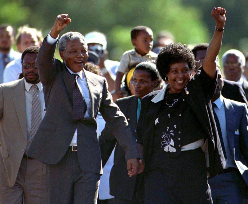 Nationalist leader Nelson Mandela (L) gestures as he is accompanied by his wife Winnie, moments after his release from Victor Verster prison in Western Cape in this February 11, 1990 file photo. Twenty years after Mandela was freed from prison, South Africa is a vibrant democracy but the millions still living in poverty are now looking for leadership that can tackle its economic problems. Mandela's release on Feb. 11, 1990, after 27 years in apartheid-era jails, set in motion the country's transformation to democracy which culminated in historic all-race elections in 1994 and his inauguration as the country's first black leader.   REUTERS/Ulli Michel/Files   (SOUTH AFRICA - Tags: POLITICS ANNIVERSARY) *** Local Caption ***  SSIB01_SAFRICA-MAND_0209_11.JPG