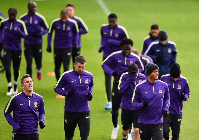 From left to right, Stevan Jovetic, Aleksandar Kolarov and Vincent Kompany of Manchester City jog during a Champions League team training session on Monday. Laurence Griffiths / Getty Images