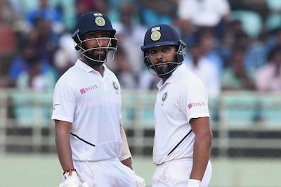 Indian cricketers Rohit Sharma (R) and Cheteshwar Pujara (L) look at the score on a big screen during the fourth day's play of the first Test match between India and South Africa at the Dr. Y.S. Rajasekhara Reddy ACA-VDCA Cricket Stadium in Visakhapatnam on October 5, 2019. ----IMAGE RESTRICTED TO EDITORIAL USE - STRICTLY NO COMMERCIAL USE-----
 / AFP / NOAH SEELAM / ----IMAGE RESTRICTED TO EDITORIAL USE - STRICTLY NO COMMERCIAL USE-----
