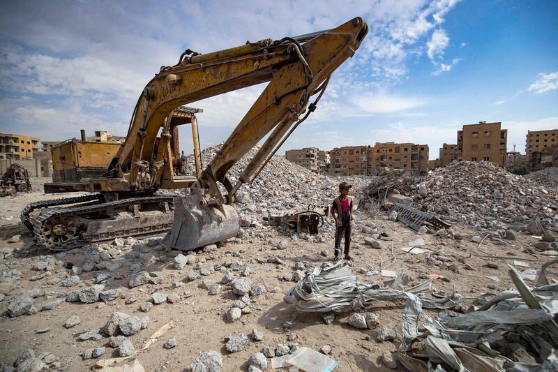 A Syrian youth collects steel rods in Raqqa.
