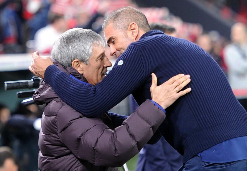 Barcelona manager Quique Setien, left,  hugs Athletic Bilbao counterpart Gaizka Garitano. AFP