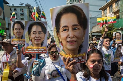 (FILES) In this file photo taken on December 10, 2019, people participate in a rally in support of Myanmar's State Counsellor Aung San Suu Kyi, as she prepares to defend Myanmar at the International Court of Justice in The Hague against accusations of genocide against Rohingya Muslims, in Yangon. A Myanmar court has charged ousted leader Aung San Suu Kyi with breaching an import and export law, a spokesperson from her National League for Democracy (NLD) said on February 3, 2021. / AFP / Sai Aung Main
