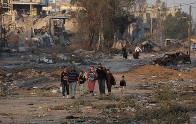 Palestinians walk along Salah Al Din Road in the central Gaza Strip. EPA