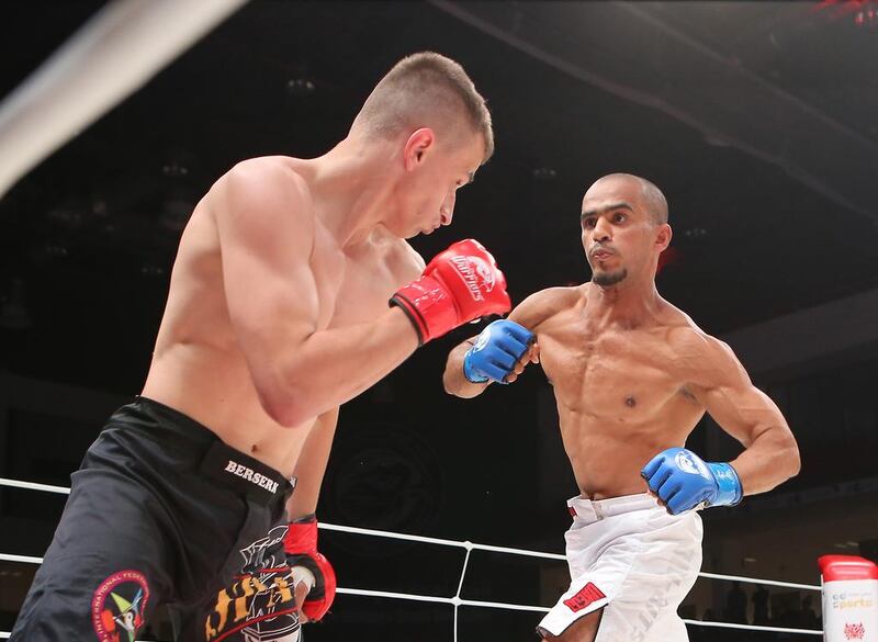 The UAE’s Ahmad Al Darmaki, in white shorts, fights with Artiyom Gorodynets from Ukraine in the Abu Dhabi Warriors 4 at IPIC Arena in Zayed Sports city in Abu Dhabi. Ravindranath K / The National