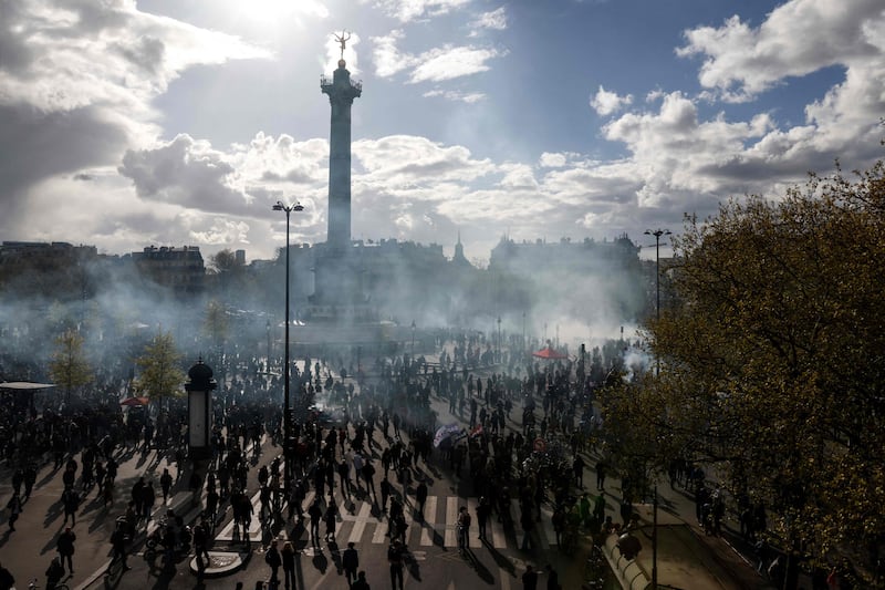 Protesters gather as smoke rises from tear gas during a demonstration in Paris. AFP