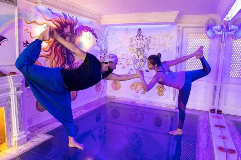 DUBAI, UNITED ARAB EMIRATES, 16 JULY 2017. 

Wiso Barakeh and Gizem Mutluay demonstrate a yoga dancer position at Taijitu House of Om (THO).

Wiso Barakeh, the founder of THO, shares his home space by offering free activities such as meditations, yoga, NLP, life coaching, sound healing, body movement  through the sound of traditional instruments, knowledge sharing through book clubs and soul cinema etc.

The house is a shared space for alternative healers, thinkers, mind body and soul specialists, as well as people interested in cultural evolution and self-development. 

(Photo by Reem Mohammed / The National)

Reporter: Haneen Dajani 
Section: NA
