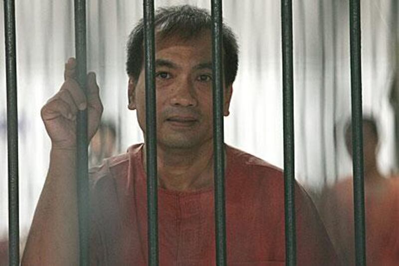 Joe Gordon, a Thai-born US citizen, looks on from his prison cell. Mr Gordon was sentenced to two and a half years in jail for translating and positing online The King Never Smiles, a biography banned in Thailand.