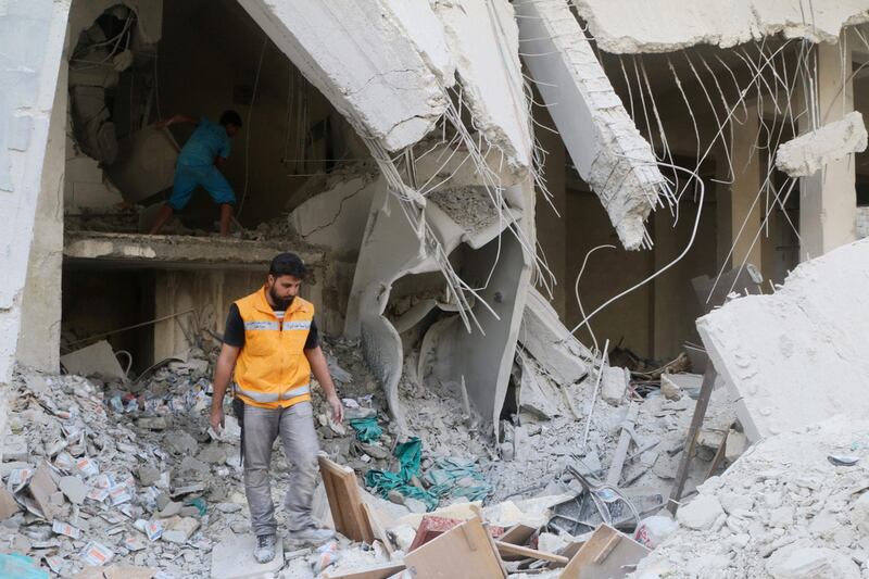 A Red Crescent aid worker inspects scattered medical supplies after an airstrike on a medical depot in the rebel-held Tariq Al Bab neighbourhood of Aleppo, Syria April 30, 2016. REUTERS/Abdalrhman Ismail