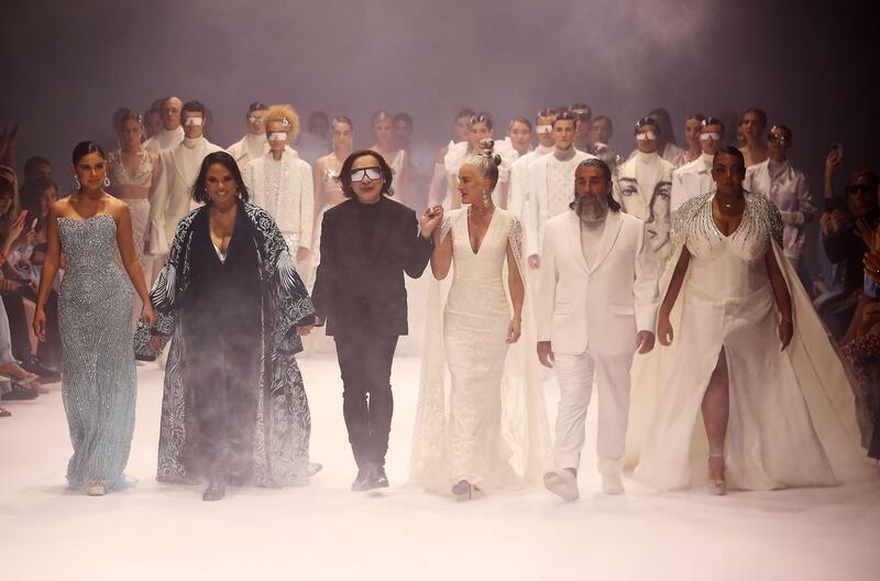 Michael Cinco takes to the catwalk at the end of his autumn/winter 2022 show.