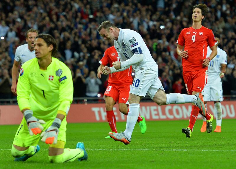 England's striker Wayne Rooney (C) celebrates after scoring from the penalty spot, his 50th goal for England, making him the country's all-time goal scorer, during the Euro 2016 qualifying group E football match between England and Switzerland at Wembley Stadium in west London on September 8, 2015.    AFP PHOTO / GLYN KIRK

NOT FOR MARKETING OR ADVERTISING USE / RESTRICTED TO EDITORIAL USE / AFP PHOTO / GLYN KIRK