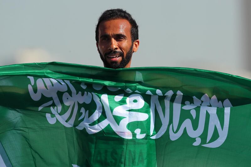 Nour Alsana of Saudi Arabia celebrates with the national flag after winning the Men's 400m T44 at the World Para Athletics Championships in Dubai. EPA