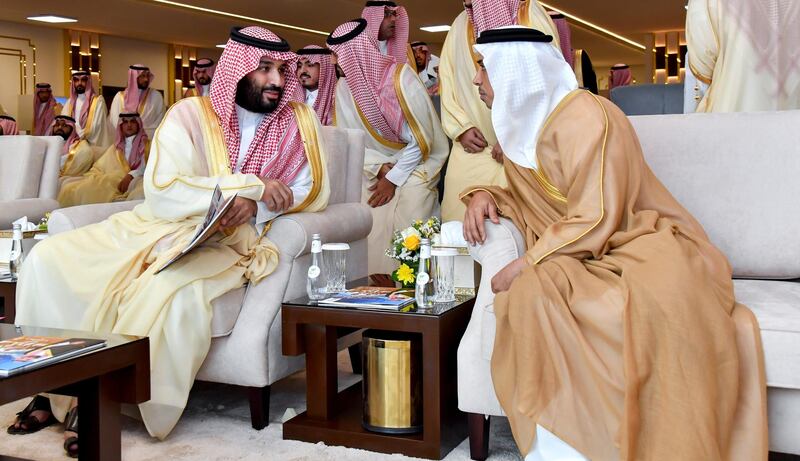 TAIF, SAUDI ARABIA - September 15, 2019:  HRH Mohamed bin Salman bin Abdulaziz Crown Prince Deputy Prime Minister and Minister of Defence of Saudi Arabia (L), speaks with HH Sheikh Mansour bin Zayed Al Nahyan, UAE Deputy Prime Minister and Minister of Presidential Affairs (R), during the concluding ceremony of the Saudi Crown Prince Camel Festival, at Taif. 

( Hassan Al Menhali for the Ministry of Presidential Affairs )
---