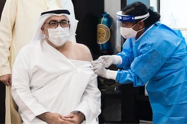 The UAE's health minister, Abdulrahman Al Owais, receiving the first dose of the Covid-19 vaccine after it was approved for emergency use in September. Wam