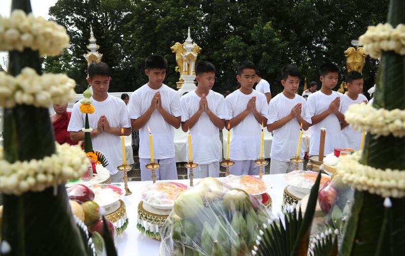Coach Ekapol Chantawong, left, and members of the team attend a Buddhist ceremony believed to extend the lives of its attendees as well as ridding them of dangers and misfortunes. AP Photo