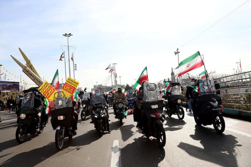 Iranians ride on motorcycles during a celebration of the 42nd anniversary of the Islamic Revolution in Tehran. WANA via REUTERS