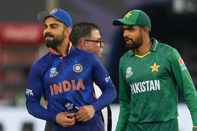 (FILES) In this file photo taken on October 24, 2021, India's captain Virat Kohli (L) and his Pakistan's counterpart Babar Azam arrive on the field for the toss during the ICC men’s Twenty20 World Cup cricket match between India and Pakistan at the Dubai International Cricket Stadium in Dubai, October 24, 2021. Aamir Qureshi / AFP