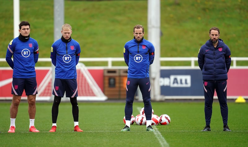 England national football team players Harry Maguire, Aaron Ramsdale, Harry Kane and manager Gareth Southgate stand in silence at St George's Park, Burton-upon-Trent. PA