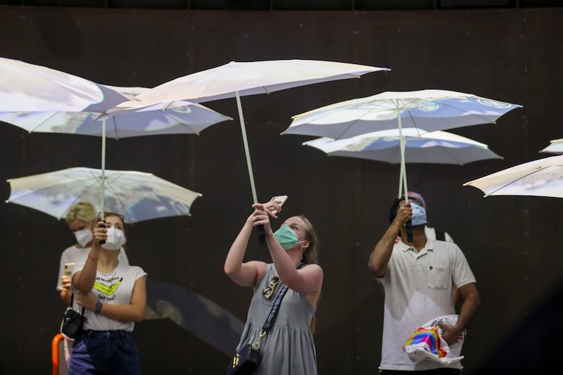 White umbrellas turn into projection screens at the Netherlands pavilion. Khushnum Bhandari/ The National