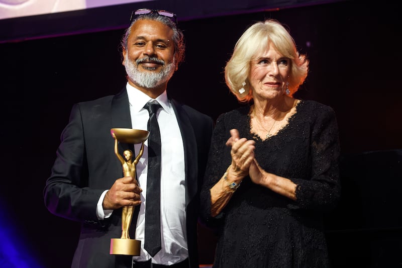 Camilla, Queen Consort presents Shehan Karunatilaka, winner of the Booker Prize 2022, with his trophy at a ceremony at the Roundhouse, London.